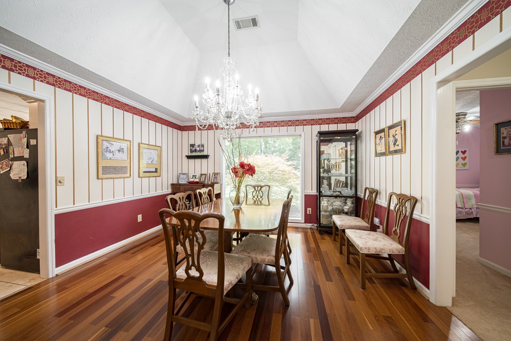 8100 Warm Springs Road Midland, GA 31820 - Photo 7 of 35 a view of a dining room with furniture a chandelier and wooden floor