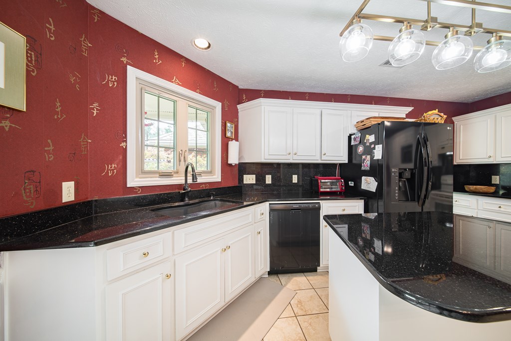 8100 Warm Springs Road Midland, GA 31820 - Photo 10 of 35 a kitchen with stainless steel appliances granite countertop a sink a stove and cabinets