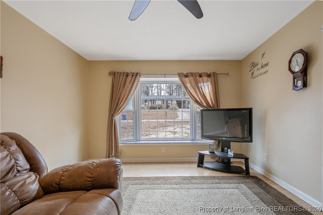 6432 Milford Road Fayetteville, NC 28303 - Photo 11 of 50 a living room with furniture a window and a flat screen tv