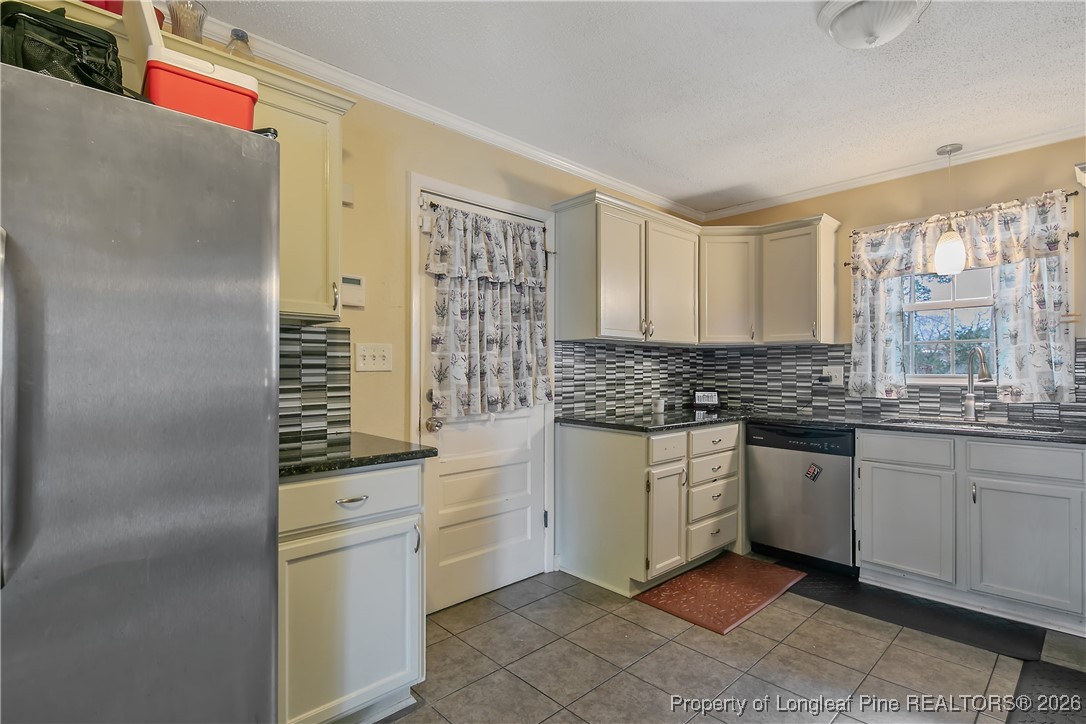 6432 Milford Road Fayetteville, NC 28303 - Photo 15 of 50 a kitchen with stainless steel appliances granite countertop a sink and a refrigerator