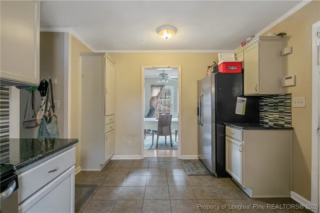 a kitchen with refrigerator and cabinets
