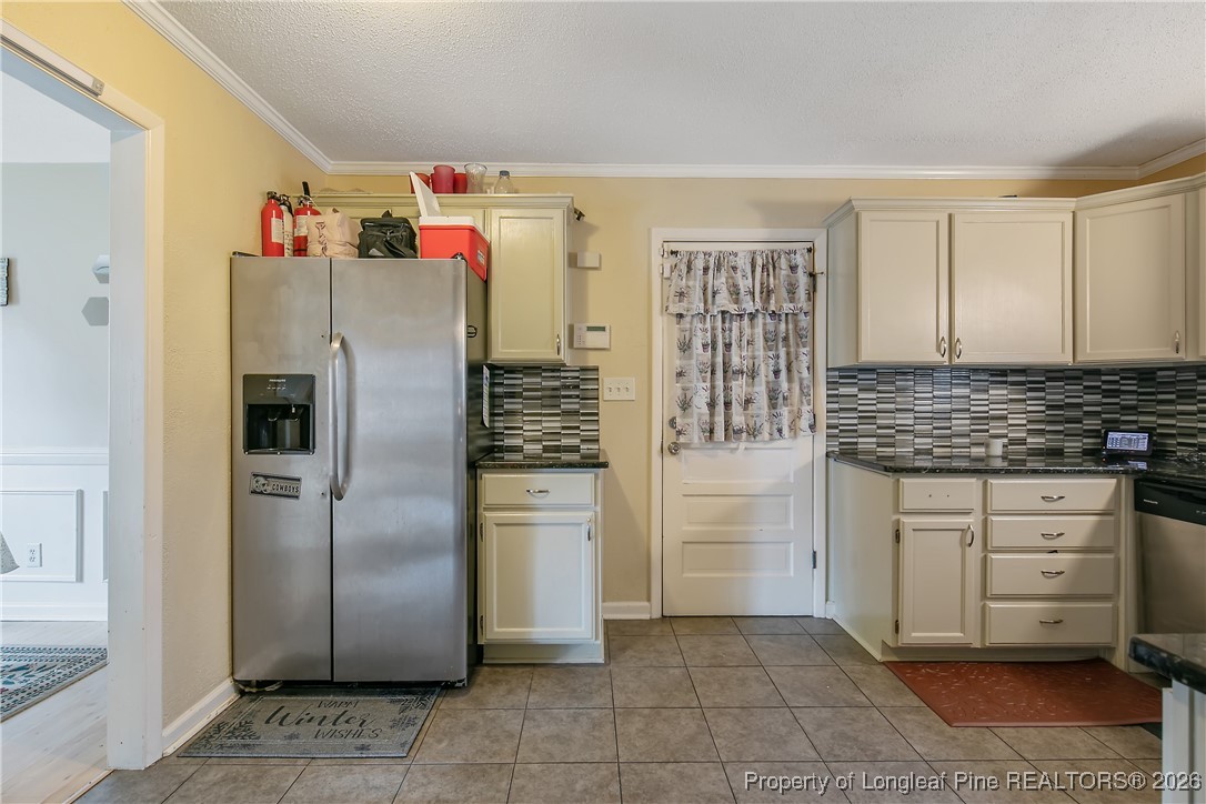 6432 Milford Road Fayetteville, NC 28303 - Photo 20 of 50 a kitchen with refrigerator and cabinets