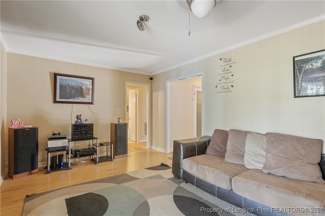 6432 Milford Road Fayetteville, NC 28303 - Photo 23 of 50 a living room with furniture and a flat screen tv