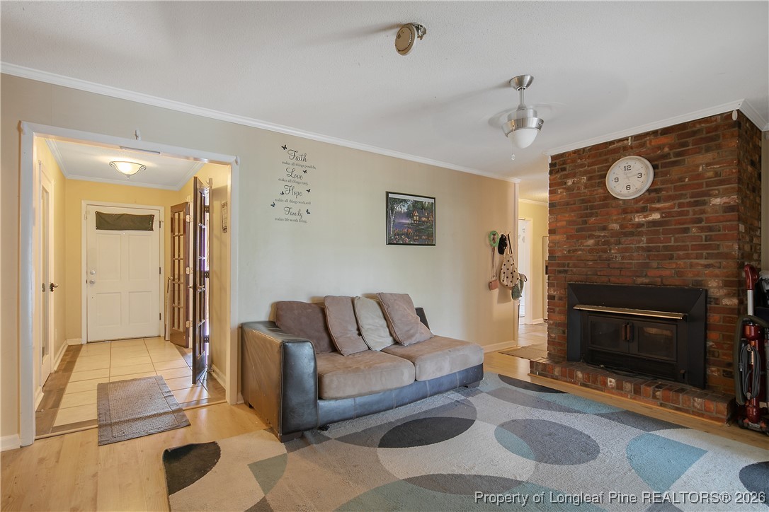 6432 Milford Road Fayetteville, NC 28303 - Photo 24 of 50 a living room with furniture and a fireplace
