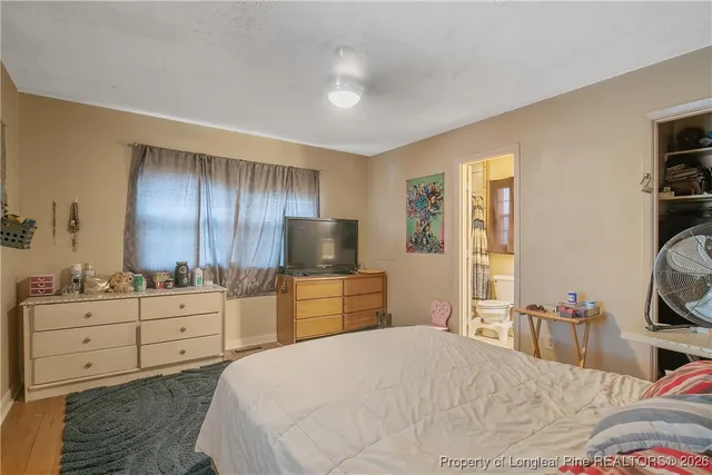 a bedroom with a bed and a wall painting