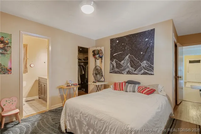 a bedroom with a bed and a painting on the wall