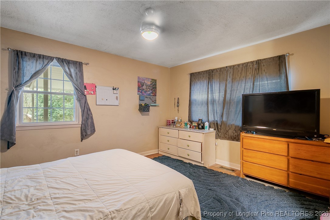 6432 Milford Road Fayetteville, NC 28303 - Photo 29 of 50 a bedroom with a bed and a flat screen tv