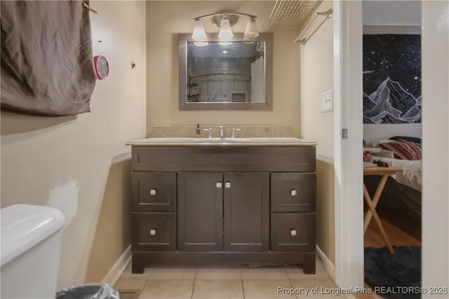 a white toilet sitting next to a bathroom sink