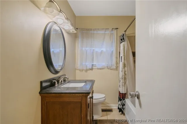 a bathroom with a shower and a window