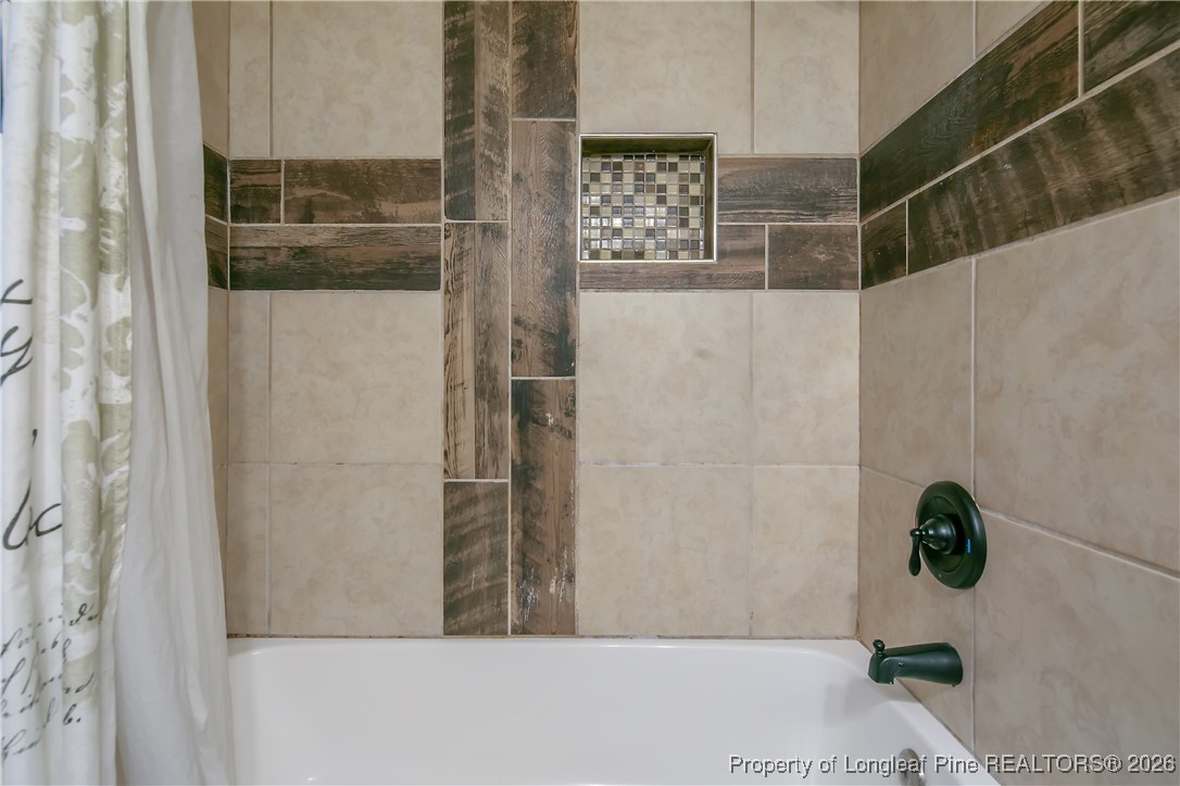 6432 Milford Road Fayetteville, NC 28303 - Photo 37 of 50 a bathroom with a shower and a window