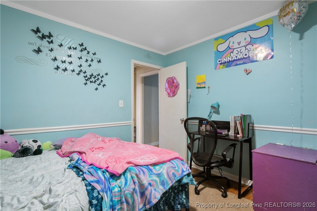 6432 Milford Road Fayetteville, NC 28303 - Photo 40 of 50 a bedroom with a bed and cabinets