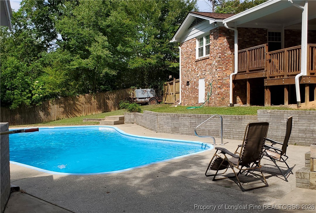 6432 Milford Road Fayetteville, NC 28303 - Photo 46 of 50 a view of a backyard with table and chairs and a barbeque