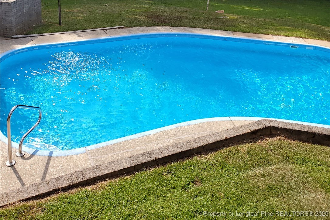 6432 Milford Road Fayetteville, NC 28303 - Photo 48 of 50 a view of a swimming pool with a yard