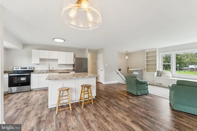a large kitchen with a table and chairs