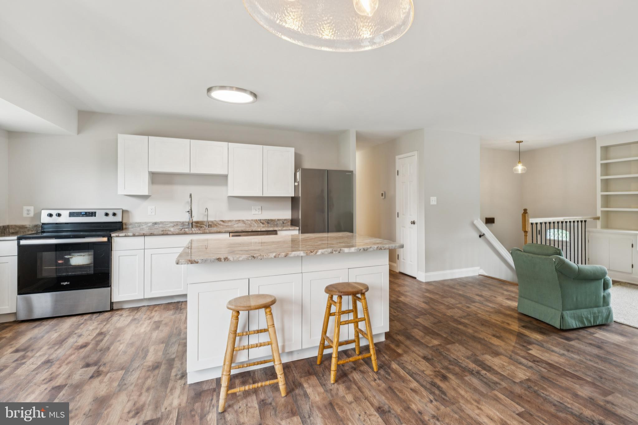 13102 Gerry Road Clinton, MD 20735 - Photo 12 of 40 a kitchen with granite countertop a stove a sink a dining table and chairs