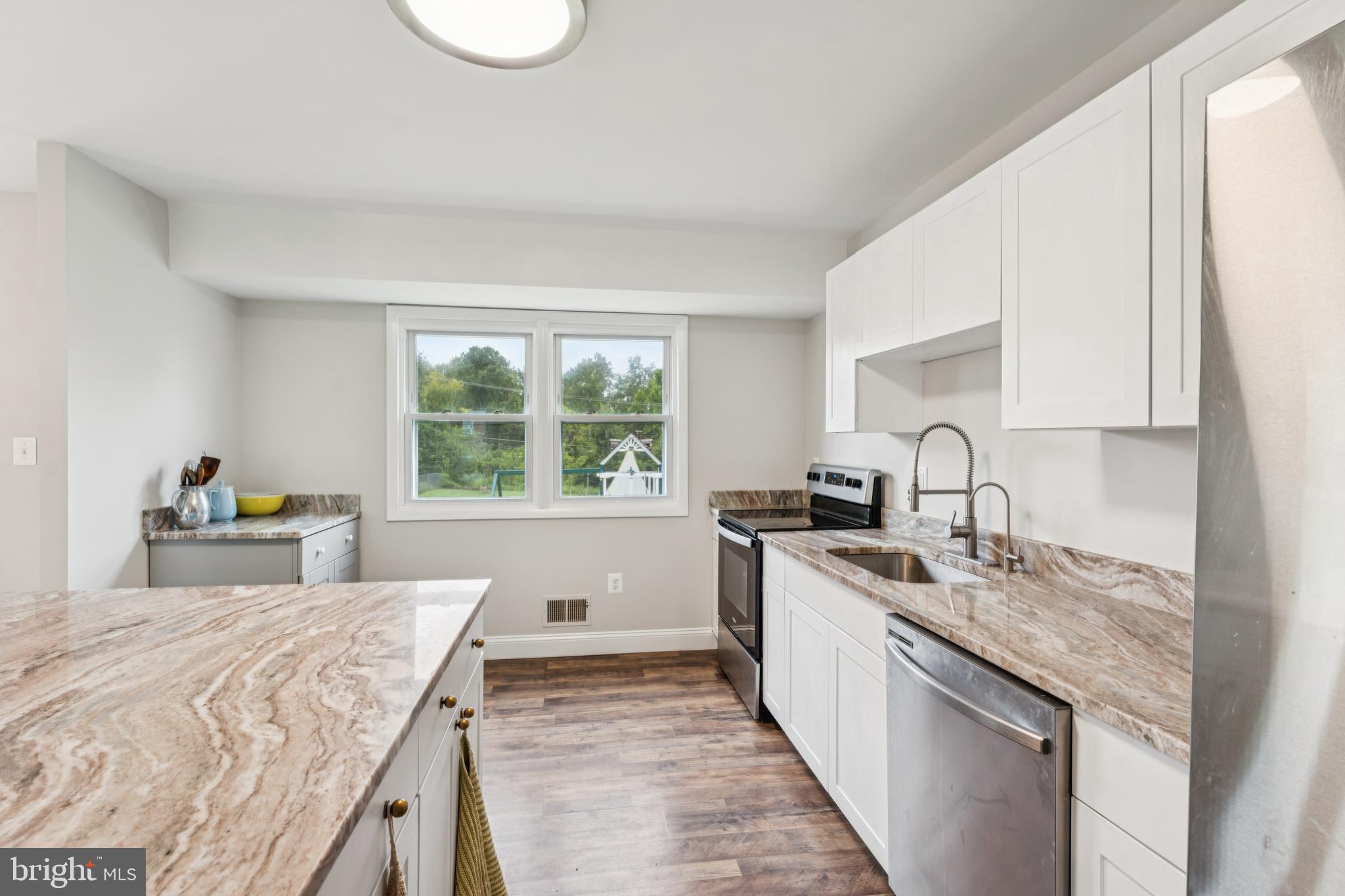 13102 Gerry Road Clinton, MD 20735 - Photo 16 of 40 a kitchen with a stove a sink and a cabinets