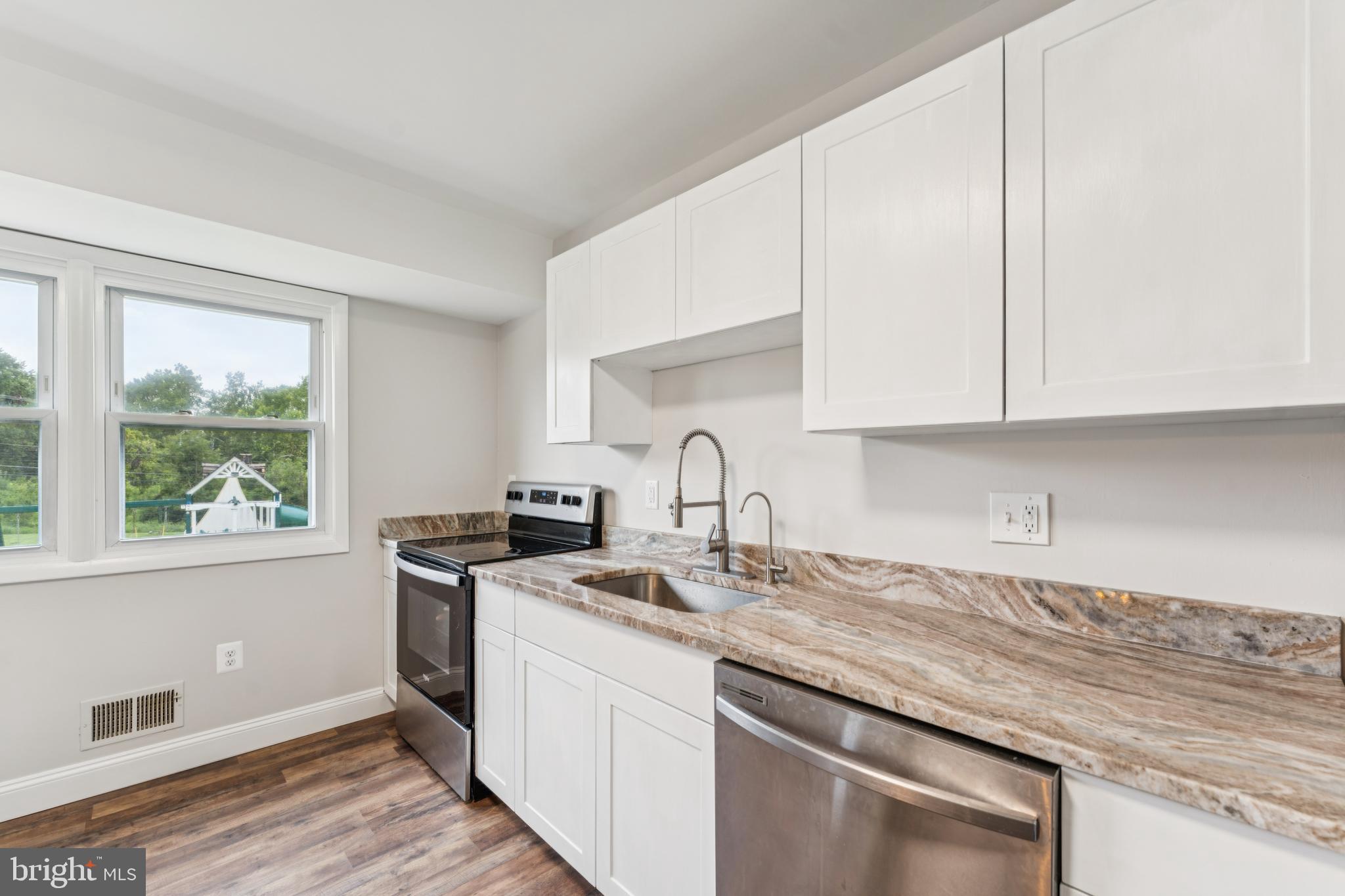 13102 Gerry Road Clinton, MD 20735 - Photo 17 of 40 a kitchen with stainless steel appliances granite countertop a sink stove and cabinets