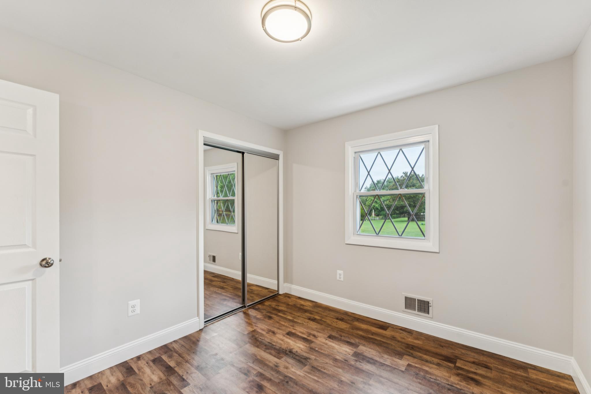 13102 Gerry Road Clinton, MD 20735 - Photo 25 of 40 an empty room with wooden floor and windows