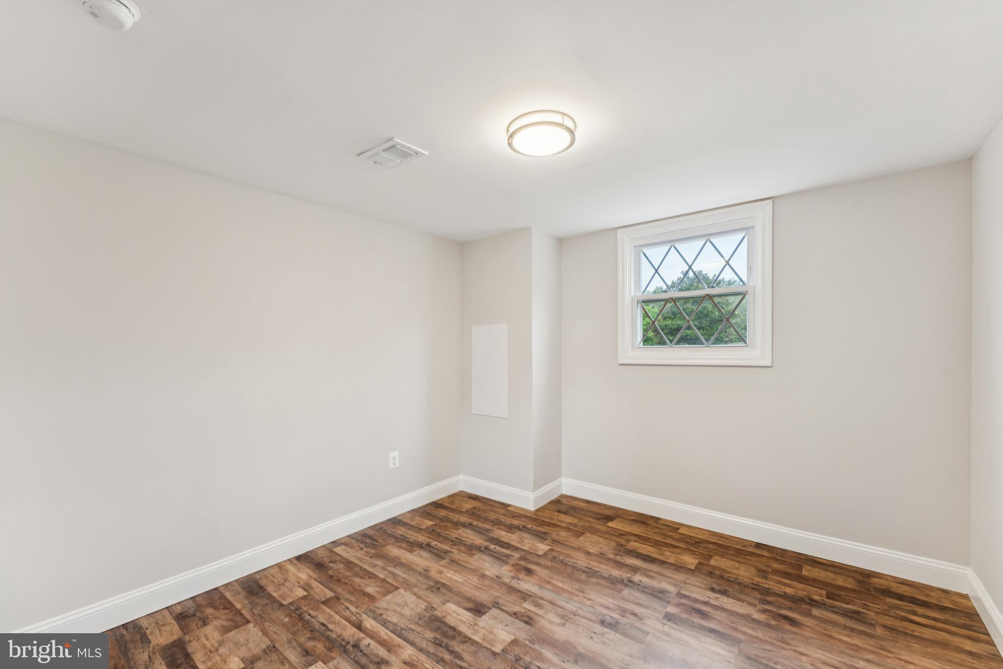 13102 Gerry Road Clinton, MD 20735 - Photo 26 of 40 a view of empty room with wooden floor and fan