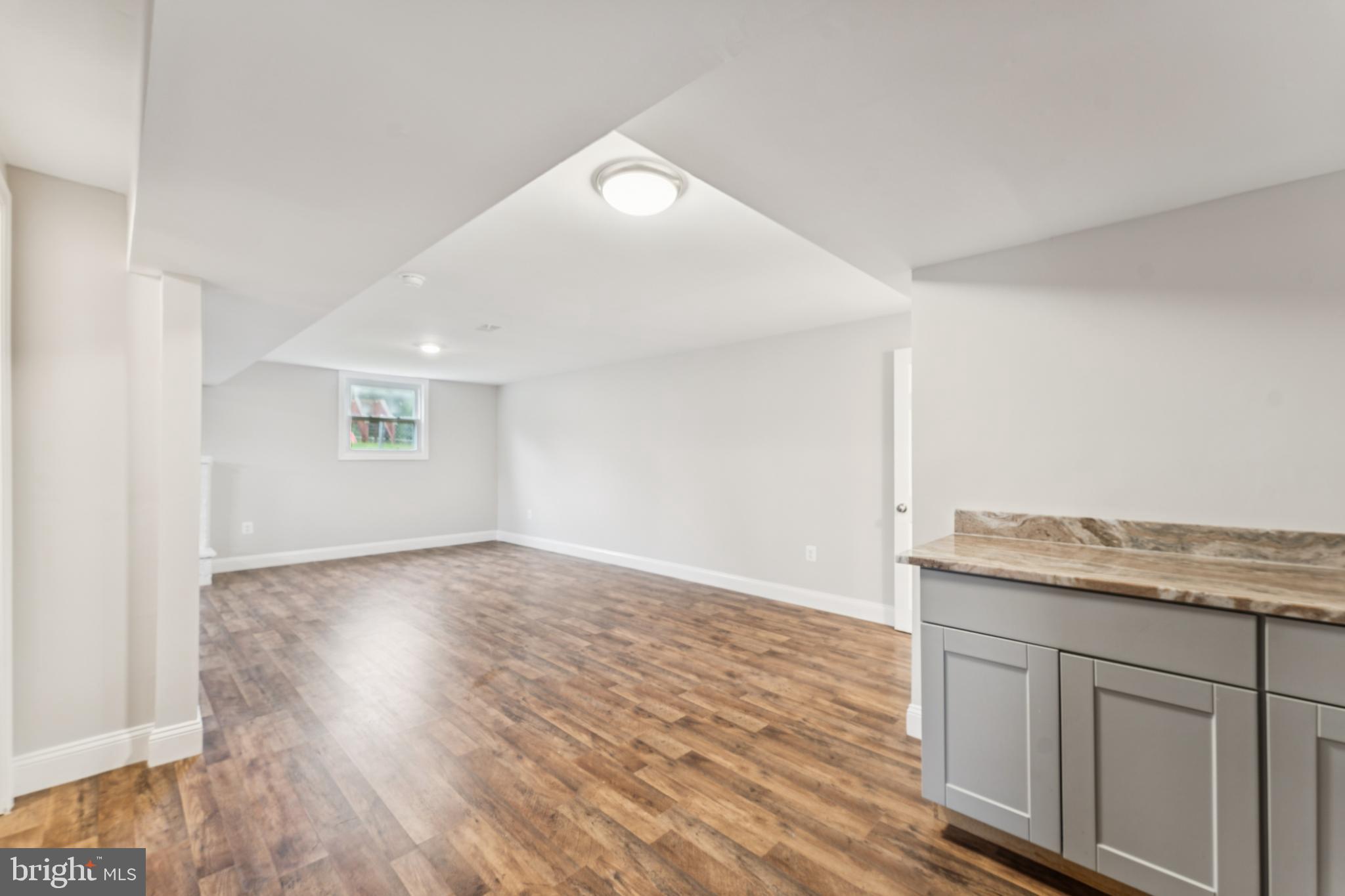 13102 Gerry Road Clinton, MD 20735 - Photo 32 of 40 an empty room with wooden floor and windows