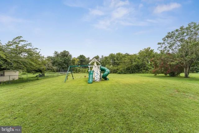 a swimming pool with lots of tress in front of it