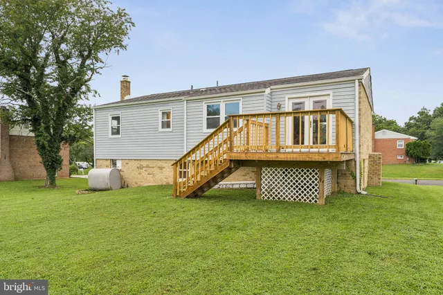 a view of a house with a yard and deck
