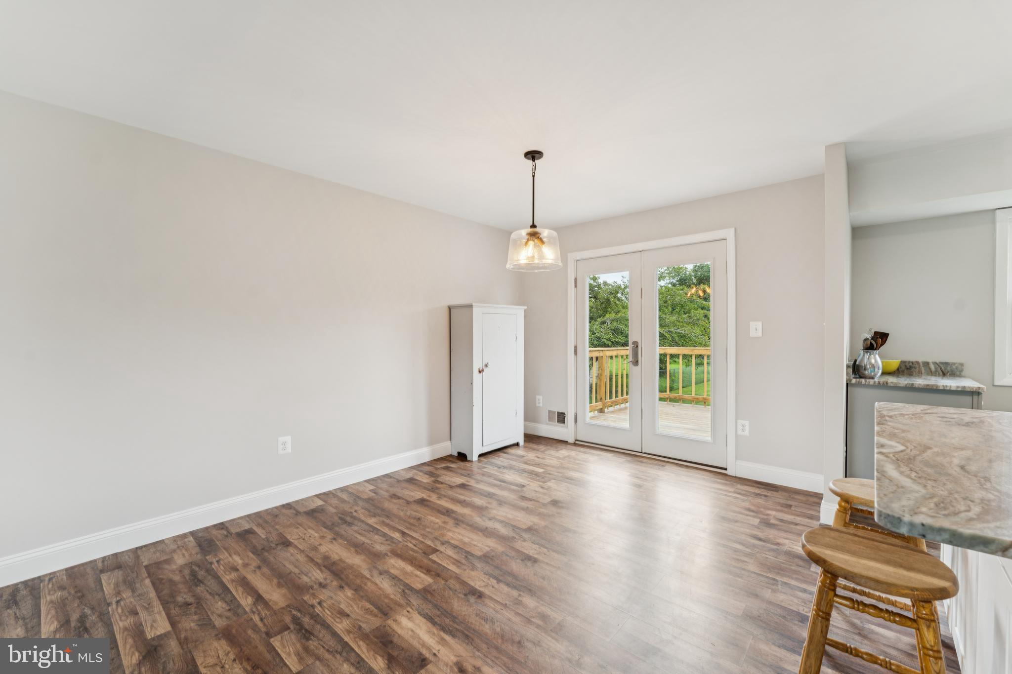 13102 Gerry Road Clinton, MD 20735 - Photo 10 of 40 a view of an empty room with wooden floor and a window