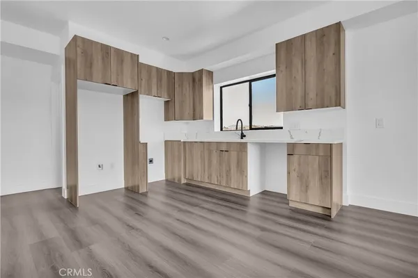 a kitchen with wooden cabinets and refrigerator