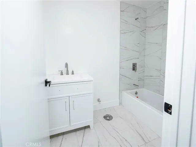 a bathroom with a sink a toilet and bathtub