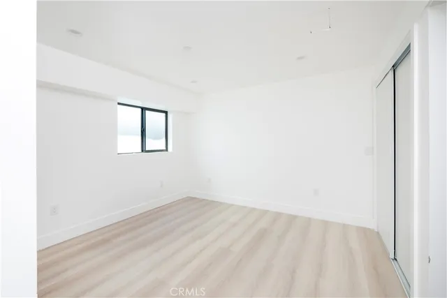 a view of a room with wooden floor and windows
