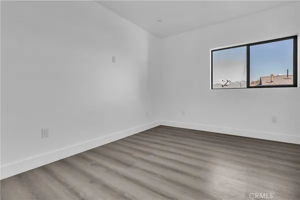 a view of a room with wooden floor