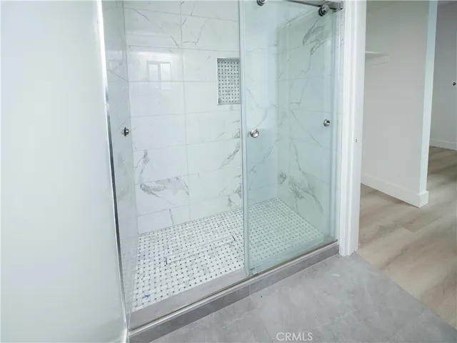 a bathroom with a glass shower door