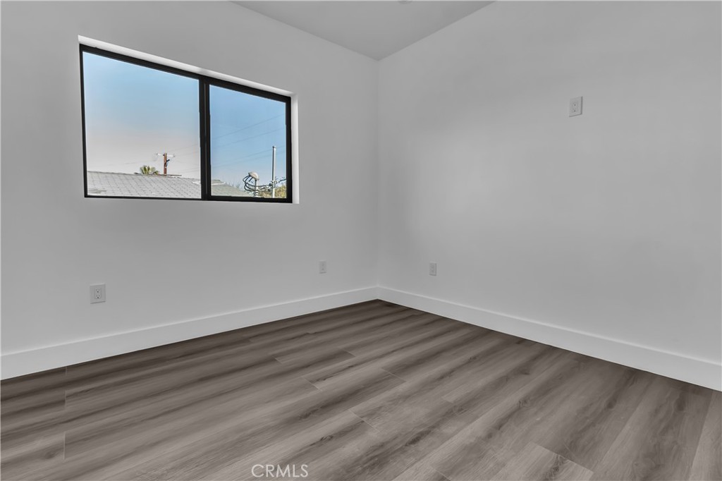 1571 Ricardo Street Los Angeles, CA 90033 - Photo 3 of 18 a view of an empty room with wooden floor and a window