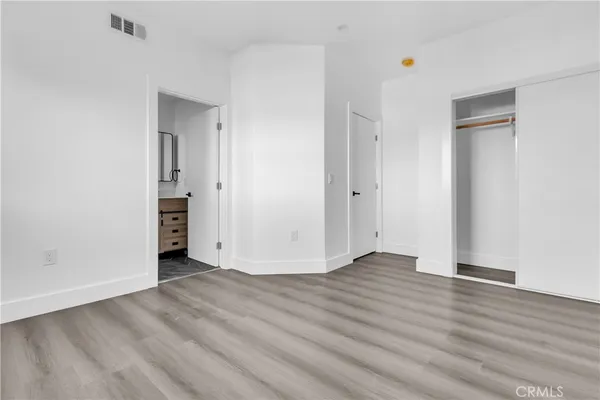 a view of an empty room and wooden floor