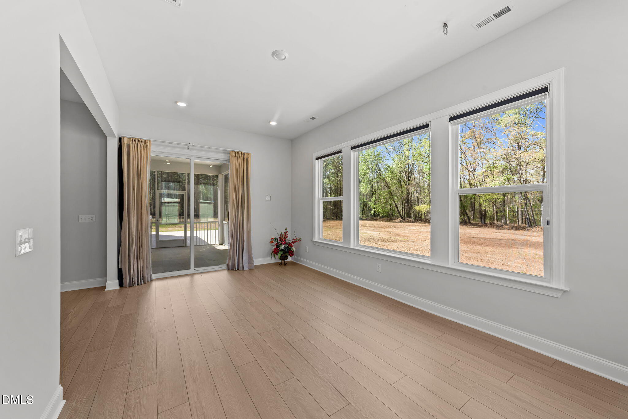 188 Flight Pattern Way Garner, NC 27529 - Photo 27 of 41 a view of an empty room with wooden floor and a window