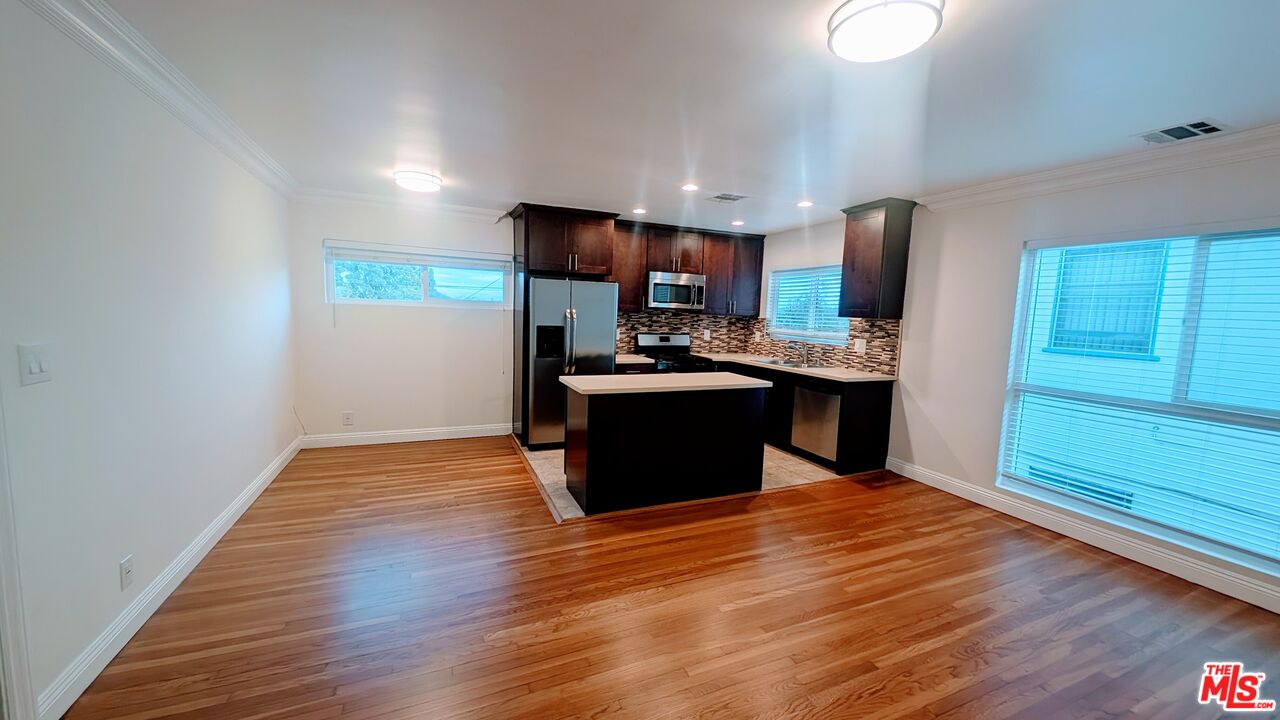 1728 South Robertson Boulevard, Unit 8 Los Angeles, CA 90035 - Photo 2 of 10 a kitchen with stainless steel appliances granite countertop a sink stove and refrigerator