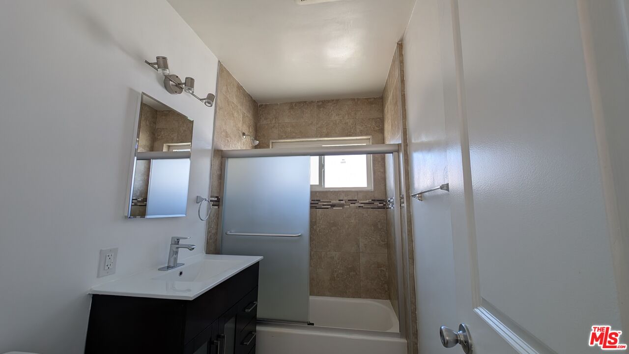 1728 South Robertson Boulevard, Unit 8 Los Angeles, CA 90035 - Photo 9 of 10 a bathroom with a sink vanity granite tub and shower