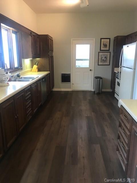 212 Pine Ridge Road Beech Mountain, NC 28604 - Photo 18 of 27 a kitchen with a sink and wooden cabinets