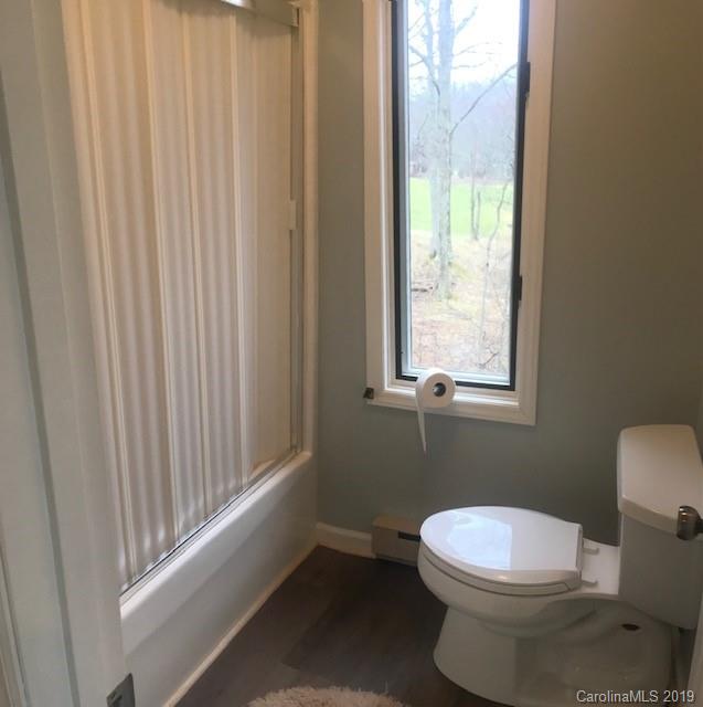 212 Pine Ridge Road Beech Mountain, NC 28604 - Photo 22 of 27 a white toilet sitting next to a window