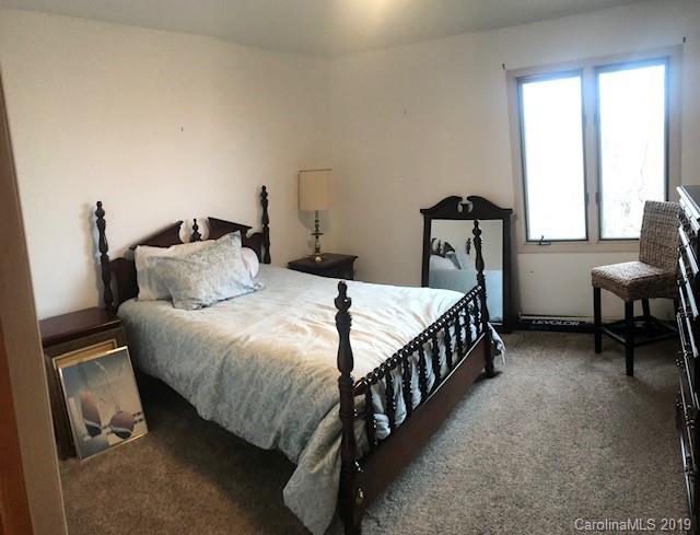 212 Pine Ridge Road Beech Mountain, NC 28604 - Photo 25 of 27 a bed sitting in a bedroom next to a window