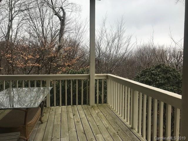 212 Pine Ridge Road Beech Mountain, NC 28604 - Photo 6 of 27 a balcony with wooden floor and trees