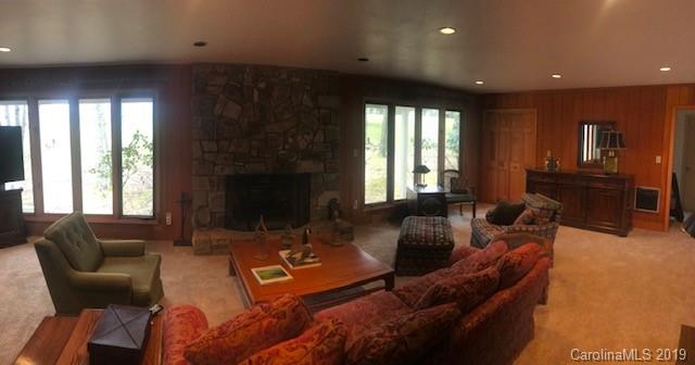 212 Pine Ridge Road Beech Mountain, NC 28604 - Photo 8 of 27 a living room with furniture and a fireplace