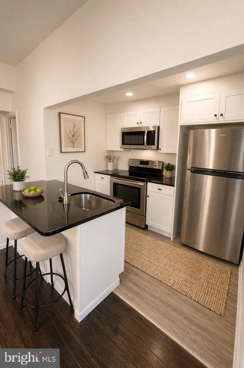 5608-00 Ridge Avenue, Unit R3 Philadelphia, PA 19128 - Photo 3 of 6 a kitchen with kitchen island a white counter top space cabinets and stainless steel appliances