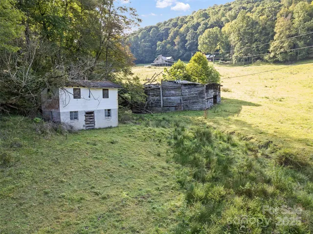a backyard of a house with lots of green space and fountain
