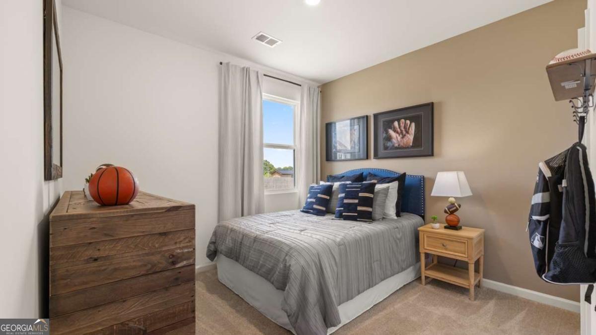 111 Cattle Drive Perry, GA 31069 - Photo 34 of 47 a bedroom with a bed and wooden floor