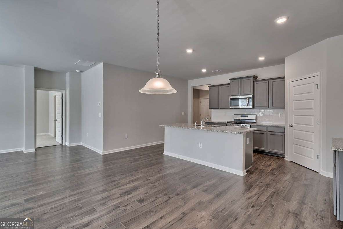 111 Cattle Drive Perry, GA 31069 - Photo 46 of 47 a kitchen with a refrigerator and white cabinets
