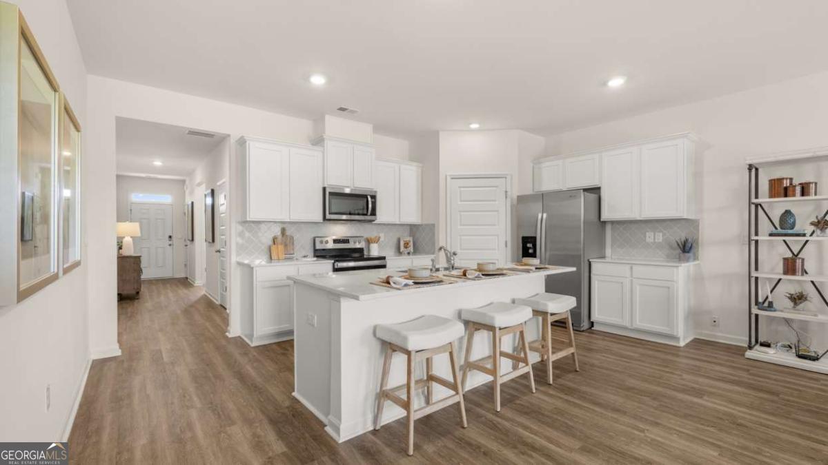 111 Cattle Drive Perry, GA 31069 - Photo 10 of 47 a kitchen with stainless steel appliances a refrigerator a stove top oven a sink dishwasher and a refrigerator