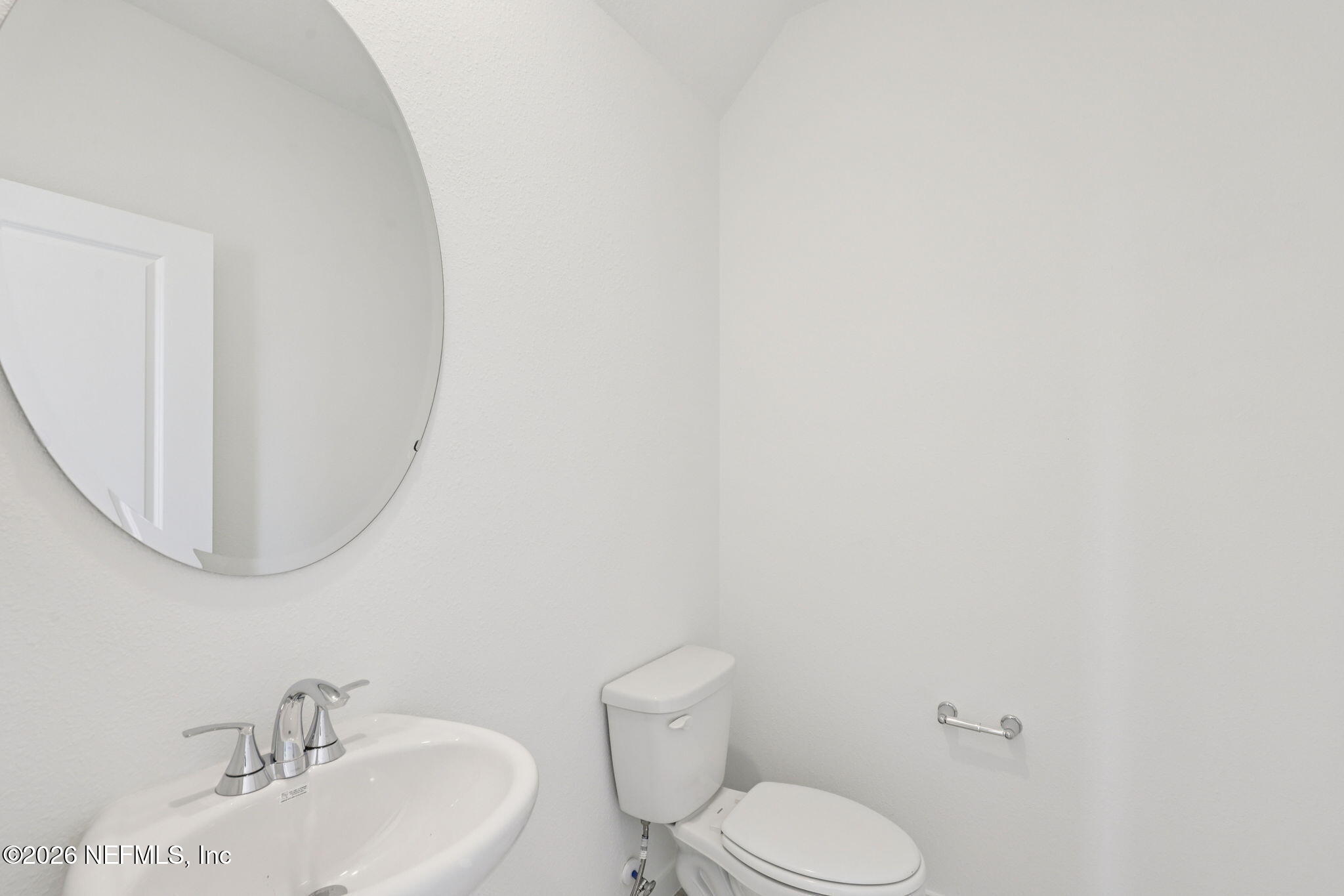 25 Rangeline Drive St. Augustine, FL 32092 - Photo 27 of 43 a bathroom with a toilet a sink and mirror