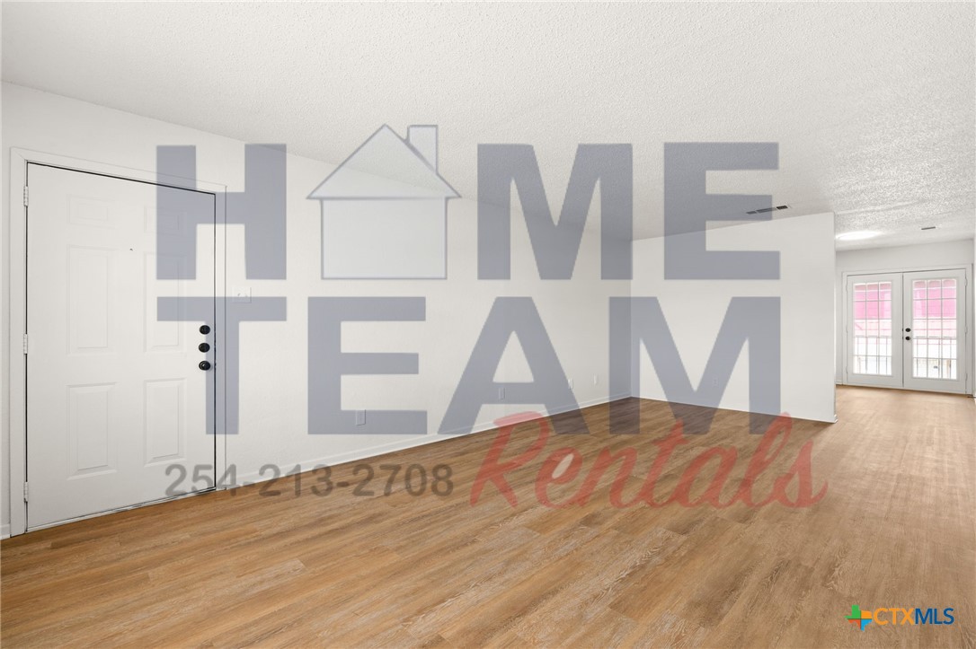 1005 Eastside Drive, Unit B Killeen, TX 76543 - Photo 3 of 11 a view of an empty room with wooden floor