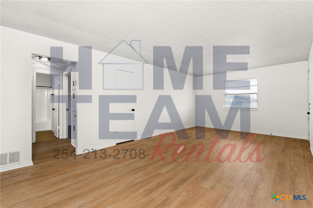 1005 Eastside Drive, Unit B Killeen, TX 76543 - Photo 4 of 11 a view of empty room with wooden floor